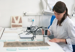 MA Textile Conservation student analysing object using colorimeter